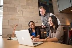 Students looking at the computer for information